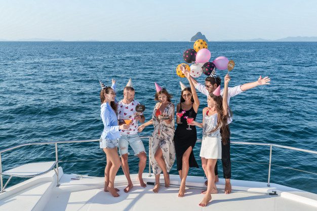 A group of people celebrating aboard a charter diving yacht.
