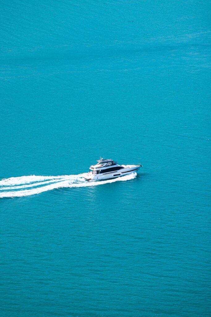 Luxury yacht driving through open Caribbean waters during all inclusive caribbean yacht charters experience