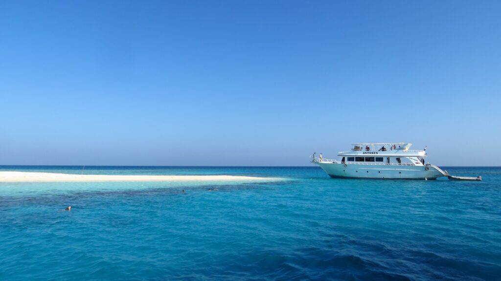 A charter yacht is on the bright blue waters of the Caribbean.