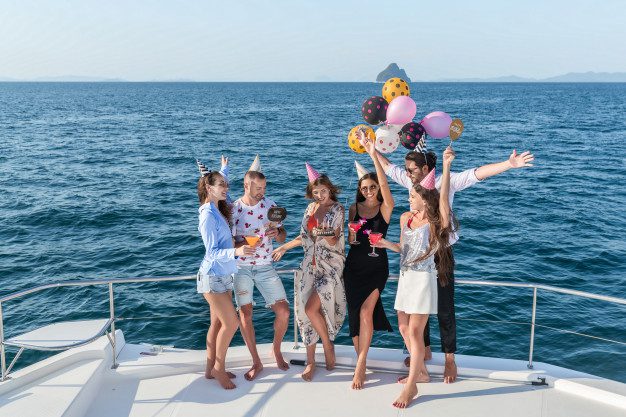A group of people celebrating aboard a charter diving yacht.