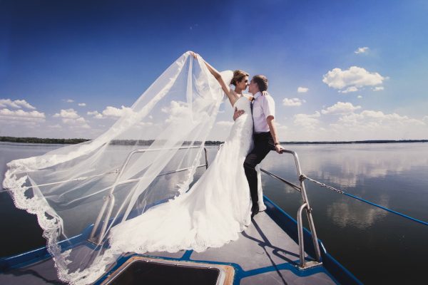 A couple getting married on an all inclusive catamaran.