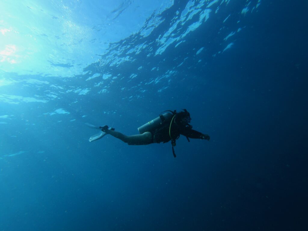 person diving deep sea on scuba diving charter fiji